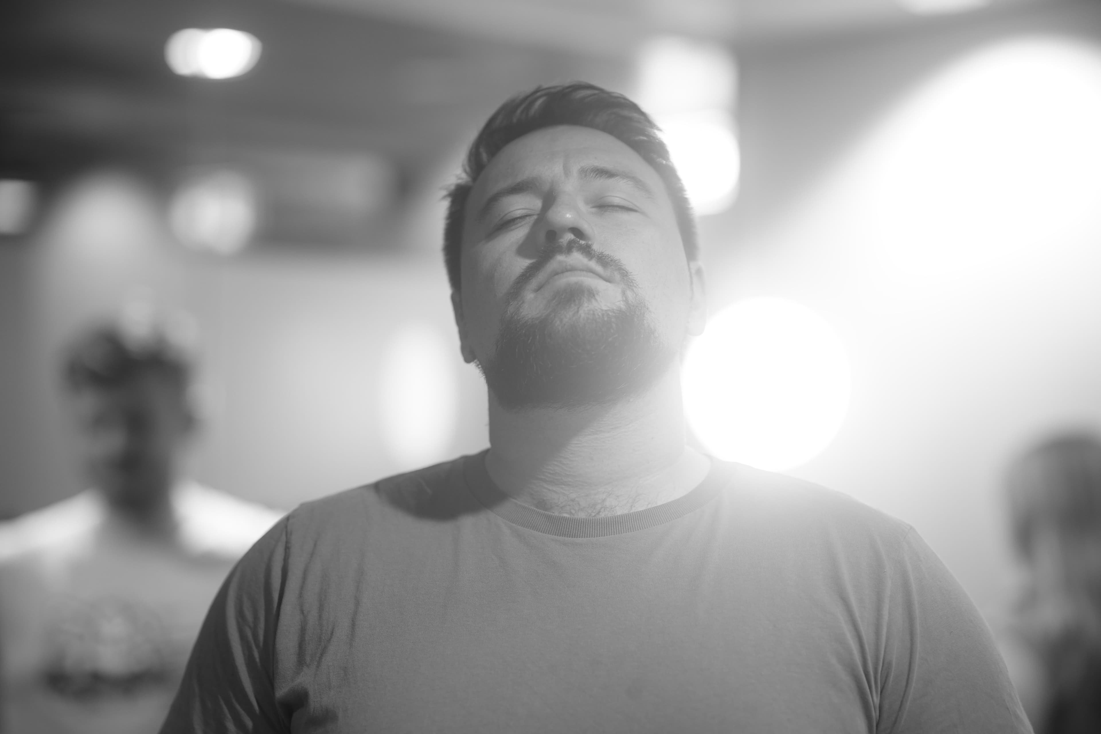Actor doing a vocal warmup with sunlight bathing over him
