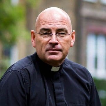 Simon Grigg headshot in dog collar