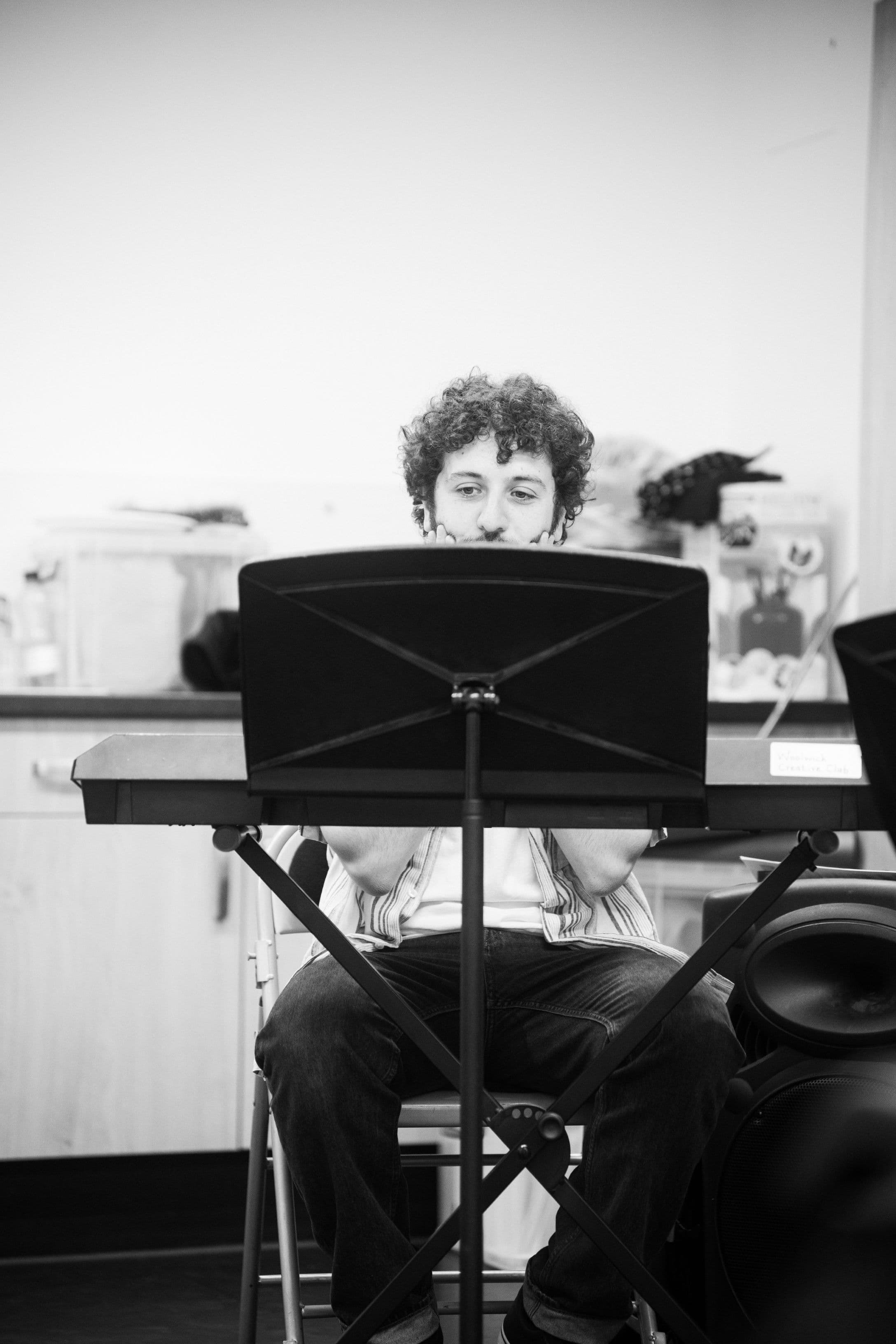 Musical Director in rehearsal room playing keyboard